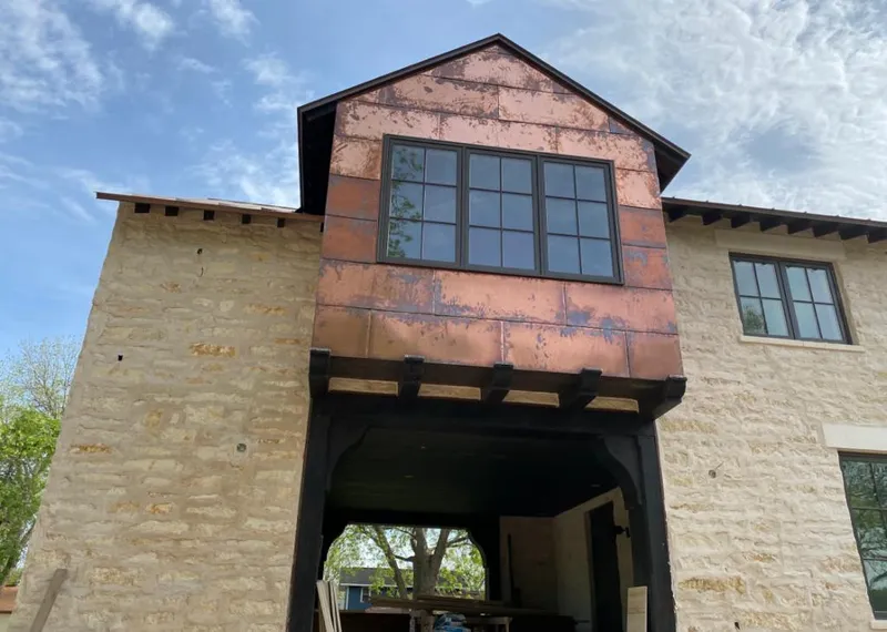 Copper metal panel facade on a stone building for Skylight Installation in Madison